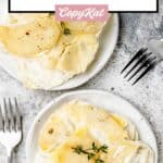 Overhead view of two plates with scalloped potatoes without cheese.