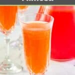 Strawberry mimosa in a champagne glass.