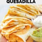 Homemade Taco Bell chicken quesadilla on a wood board.