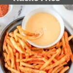 Overhead view of homemade Taco Bell nacho fries and cheese sauce on a plate.