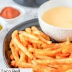 A plate of homemade Taco Bell nacho fries with dipping sauce.