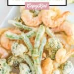 Overhead view of homemade tempura batter vegetables and shrimp.