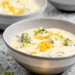 Three cheese broccoli soup in three bowls.