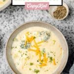 Overhead view of three cheese broccoli soup in a grey bowl.
