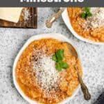 Overhead view of homemade Tosi's minestrone soup in bowls and parmesan cheese.