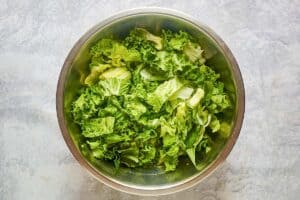 Chopped lettuce for Brown Derby cobb salad in a bowl.