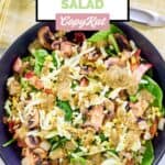 Overhead view of homemade Chart House spinach salad with bacon dressing.