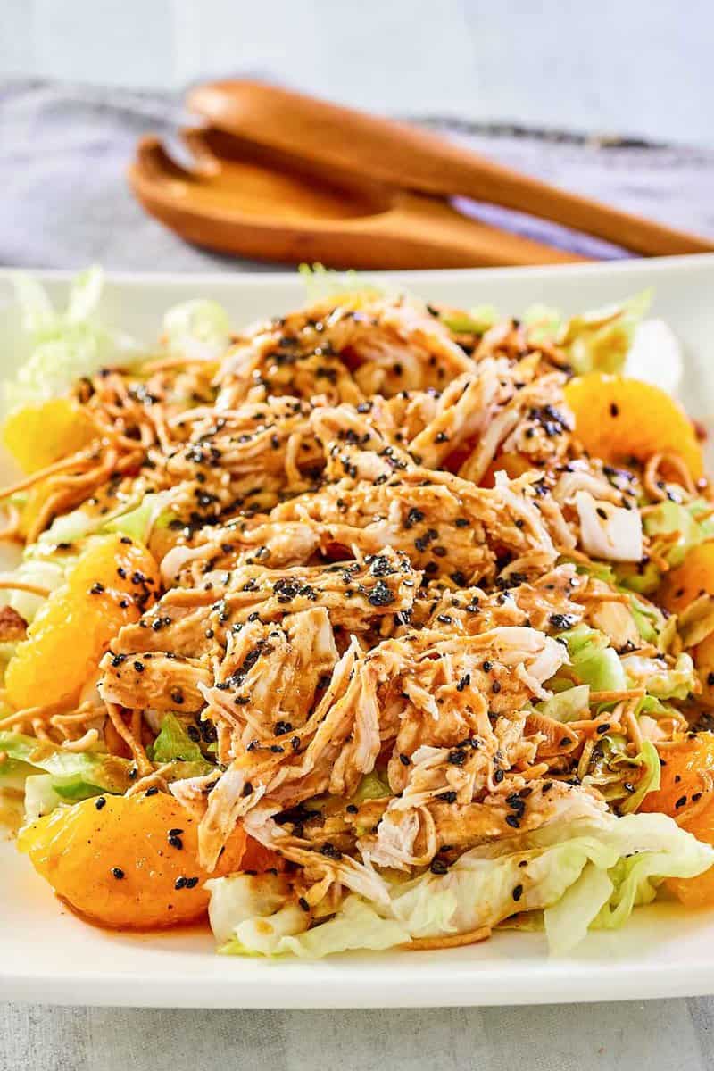 Chinese chicken salad and salad tongs.