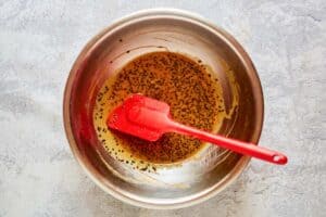 Adding sesame seeds and oil to Chinese chicken salad dressing mixture.