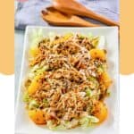 Chinese chicken salad with mandarin oranges on a platter.