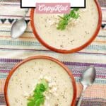 Overhead view of two bowls of creamy crab bisque.