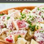 A bowl of red potato salad with dill.