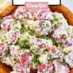 Overhead view of red potato salad with dill.