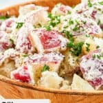 Closeup of dill red potato salad in a wood bowl.