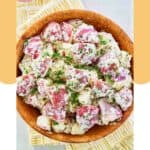 Overhead view of dill red potato salad in a wood bowl.