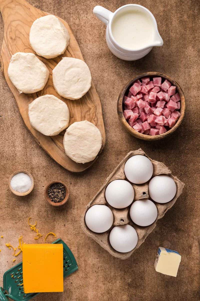 Copycat Dunkin Donuts stuffed biscuit bites with ham ingredients on a wood surface.