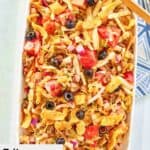 Overhead view of frito taco salad on a large white platter.