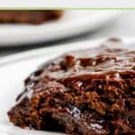 Closeup of a hot fudge cake slice on a plate.