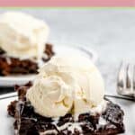 Two slices of hot fudge cake with vanilla ice cream on top.