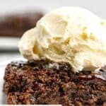 Closeup of hot fudge cake with vanilla ice cream on top.