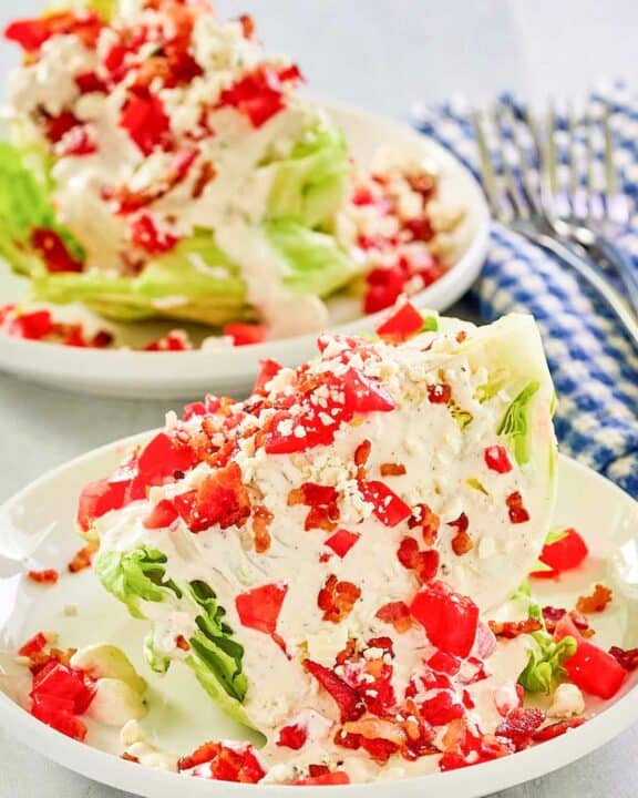 Maytag buttermilk blue cheese dressing and chopped tomatoes on iceberg lettuce wedges.