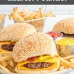 Homemade McDonald's quarter pounder burgers with cheese, fries, mustard, and ketchup.