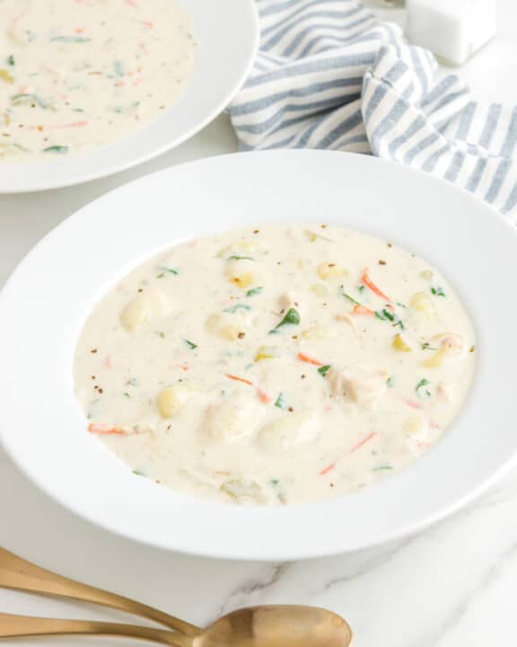 Copycat Olive Garden chicken gnocchi soup in two bowls.