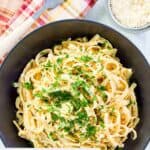 Overhead view of homemade Pasta House fettuccine alfredo in a black bowl.