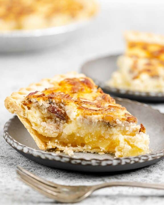 Pineapple pie slice with the pie in the background.