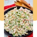 Seafood pasta salad and wood salad servers.
