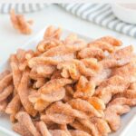 Homemade Taco Bell cinnamon twists on a square white plate.