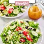 Traditional Greek salad on two plates and a small pitcher of the dressing.