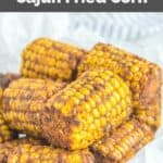 Homemade Wingstop cajun fried corn cobs on white parchment paper.