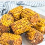 Homemade Wingstop cajun fried corn on the cob on a white plate.