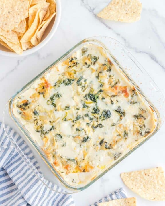 Overhead view of copycat Applebee's spinach artichoke dip and tortilla chips.