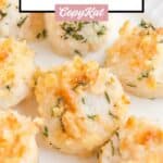 Closeup of baked scallops with Ritz cracker topping.