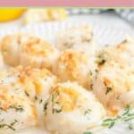 Baked scallops topped with Ritz cracker crumbs on a plate.