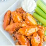Closeup overhead view of homemade Buffalo Wild Wings Buffalo wings on a plate.