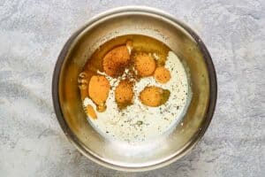 Eggs, half-and-half, and seasonings in a bowl.