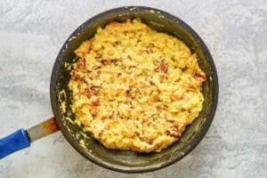 Bacon egg and cheese mixture in a skillet.