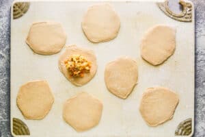 Filling biscuit dough with bacon egg and cheese.