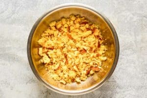 Crumbled cornbread muffins in a bowl.