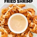 Overhead view of homemade Outback bloomin shrimp and dipping sauce on a platter.