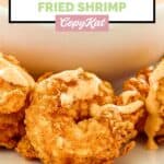Closeup of homemade Outback bloomin fried shrimp drizzled with bloomin sauce.