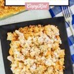 Overhead view of Ritz cracker chicken casserole on a square black plate.