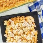 Overhead view of a serving of Ritz cracker chicken casserole on a black plate.
