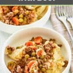 A bowl of shepherd's pie made with gravy and ground beef.