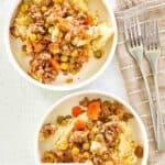 Overhead view of two bowls of shepherd's pie made with beef and gravy.