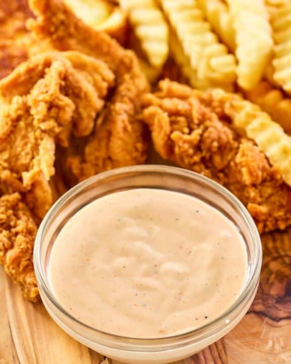 Copycat Zaxby's zax sauce, fried chicken fingers, and crinkle-cut fries.