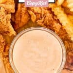 Overhead view of homemade Zaxby's zax sauce next to chicken fingers and fries.